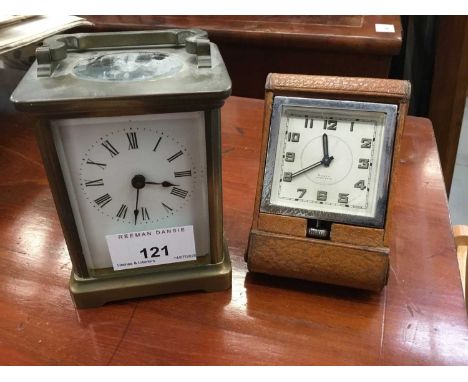 Brass carriage clock with white enamel dial, together with a brown leather cased travelling clock (2)