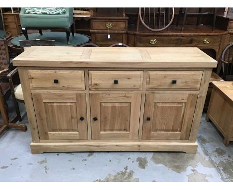 Light oak sideboard with three drawers and cupboards below