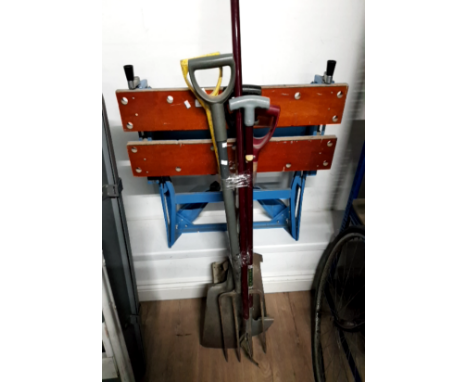 A BUNDLE OF GARDENING TOOLS AND A WORK BENCH