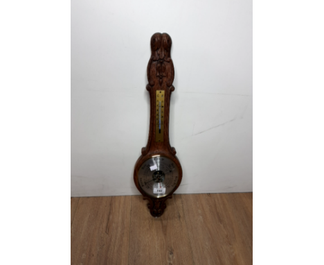 A CARVED OAK BAROMETER