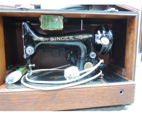 A vintage electric Singer sewing machine in case