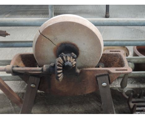 A vintage sharpening/wet stone on stand