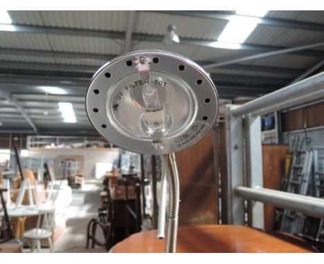 A modern brushed metal adjustable room lamp