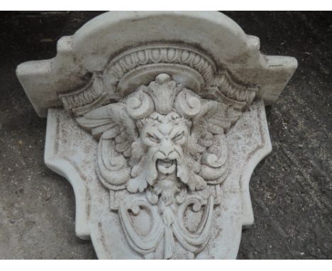 A marble effect wall shelf having lion decoration