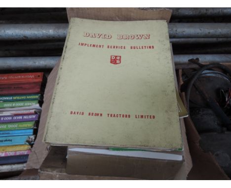 A box of various vintage agricultural machinery manuals and ephemera