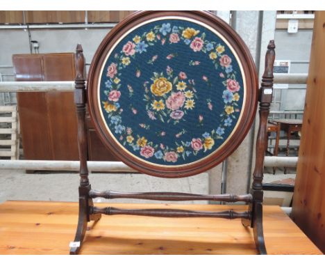 A modern stained foster frame firescreen having circular woolwork inset
