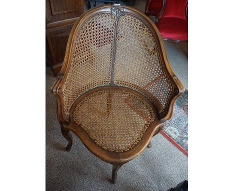 A Victorian Bergere Armchair, Having a serpentine shaped seat, 89cm high 