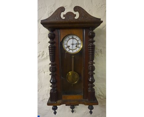 A Mahogany Cased Vienna Wall Clock, circa early 20th century, with a twin train enamel dial, with pendulum and key, 84cm high