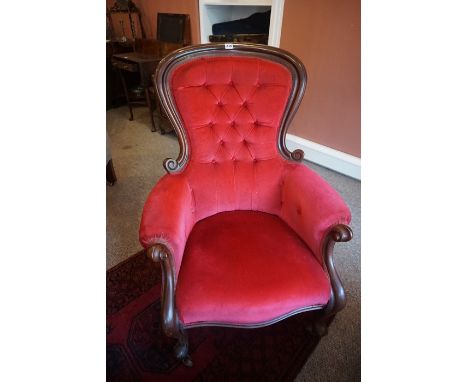 A Victorian Mahogany Gents Armchair, Upholstered in later red button back velour, raised on scroll legs with castors, 102cm h