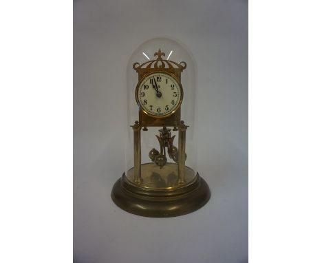 A German Brass Anniversary Clock, 20th century, with initial B to dial, 23cm high, beneath a glass dome
