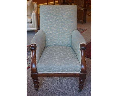 A Victorian Mahogany Armchair, Upholstered in later fabric, raised on turned legs with brass castors, 100cm high