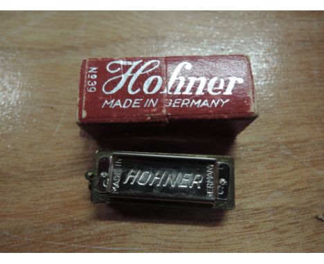 A Hohner number 39 miniature harmonica in original box