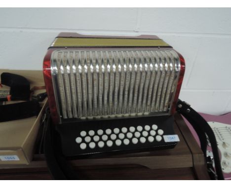 A Hohner button accordion in semi hard case