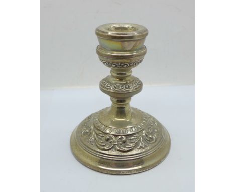 A silver candlestick, marked 'filled' 