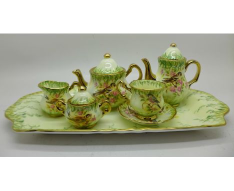 A Lymes China miniature tea service with tray, decorated in the Victorian Birds design 
