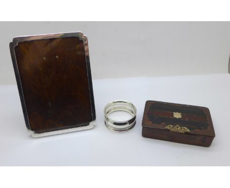 A silver photograph frame, a silver napkin ring and a Georgian snuff box, frame 9.5cm x 13cm, (snuff box worn) 