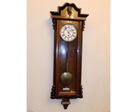 A 19thC walnut cased Vienna regulator, the two piece white enamel dial with subsidiary seconds, single brass weight.  Separat