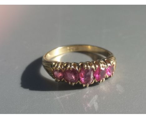 An old five stone graduated ruby ring on '18ct' shank.  Finger size M.