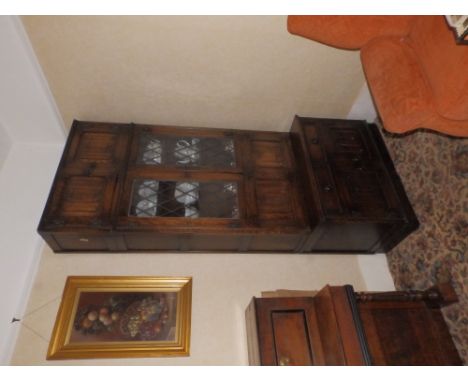A tall oak reproduction bookcase/cupboard unit having leaded light doors, Height 92", Width 38".  Separate viewing arrangemnt
