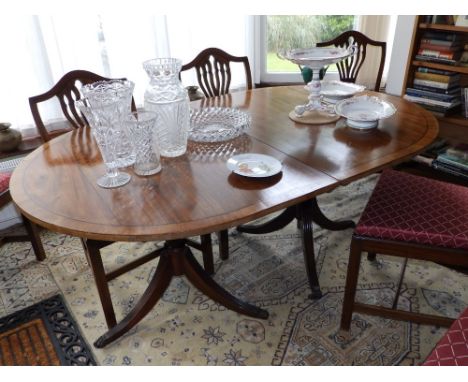 A 20thC reproduction mahogany twin pillar dining table.  Separate viewing arrangements by appointment.