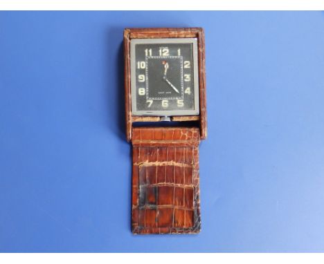 A LeCoultre travelling 8 day clock in brown leather crocodile effect case,  the clock case 2.1" overall.