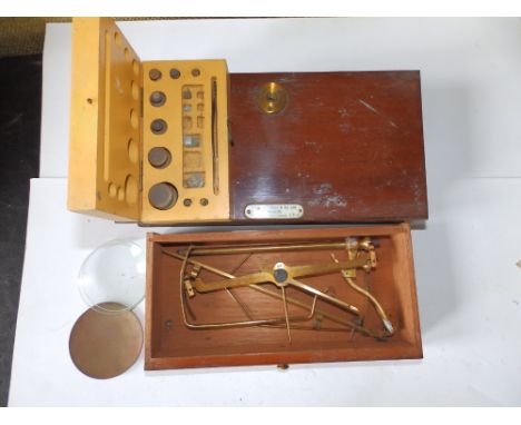 A 19thC mahogany cased set of travelling scales and some weights.