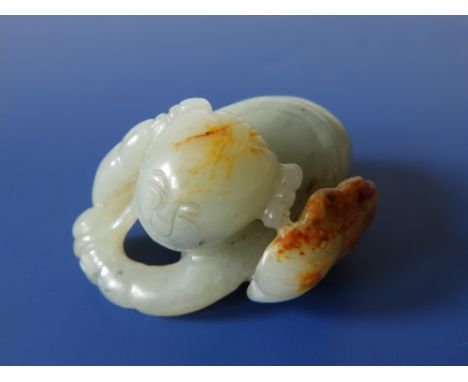 A small Chinese jade study of a crouching boy,  2" across.