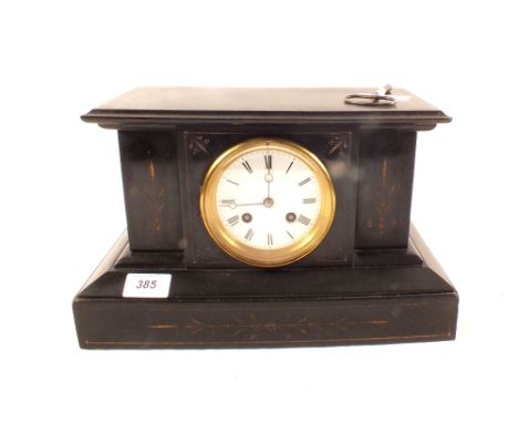 A black slate mantel clock with unassociated spelter figure of a seated lady holding compass and dividers
