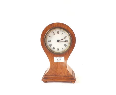 An Edwardian mahogany cased waisted mantel clock