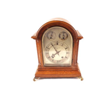 An oak striking mantel clock, silvered dial marked John Dyson & Sons, Leeds