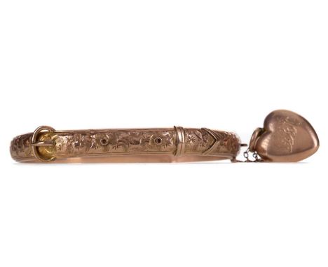 GOLD BUCKLE BANGLE,in nine carat gold with attached heart shaped mourning locket with engraved initials to the exterior and c