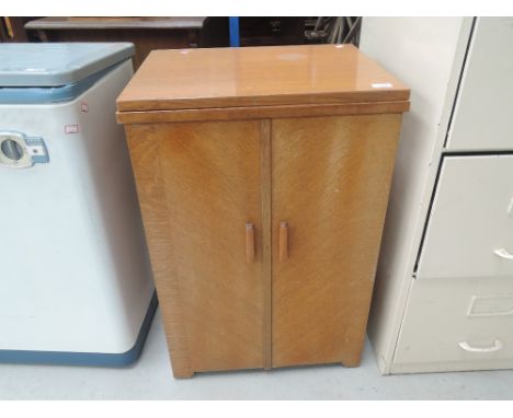 A  vintage singer sewing machine in oak cabinet