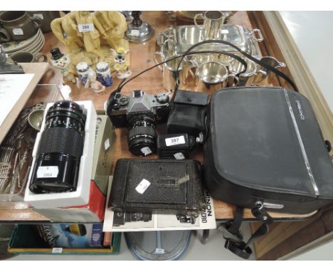 A selection of vintage cameras and equipment including Canon AE-1 zoom lens etc