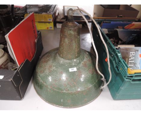 A large industrial style light or lamp shade in enamel green with aged patina
