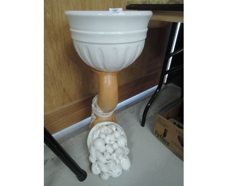 A large ceramic planter in the form of a horn of plenty with white glaze