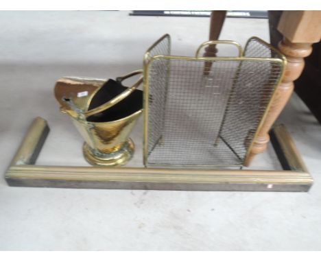 A selection of brassware including coal hekmet, fender and fireguard