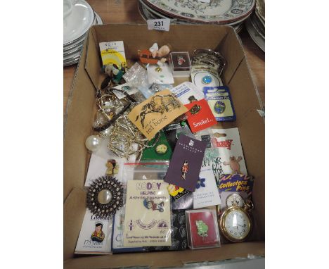 A selection of vintage curios and trinkets including enamel pin badges