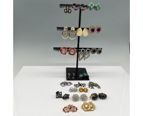 A diverse assortment of vintage and costume earrings. This collection features a wide variety of designs, including colorful 