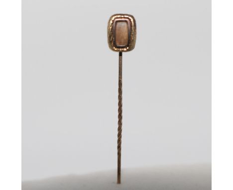This elegant vintage stick pin is crafted from sterling silver and features a rectangular glass cabochon at its center. The p