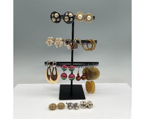 A curated collection of assorted vintage and contemporary costume earrings, featuring a mix of clip-on and pierced styles. Th