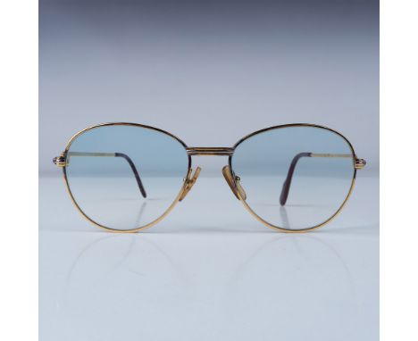 A vintage pair of Cartier aviator-style glasses featuring a gold-plated frame with a classic design. These glasses have light