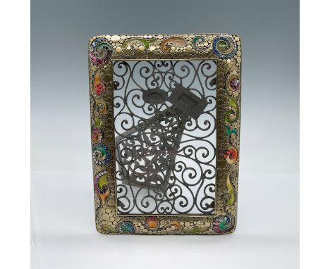 A beautiful Tizo filigree frame measuring 5.75"L x 8.75"H. This intricately designed piece features brass-toned metal with de