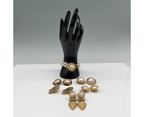 Elegant Carolee jewelry featuring a gold-tone triple-strand faux pearl bracelet with a large central pearl surrounded by a te