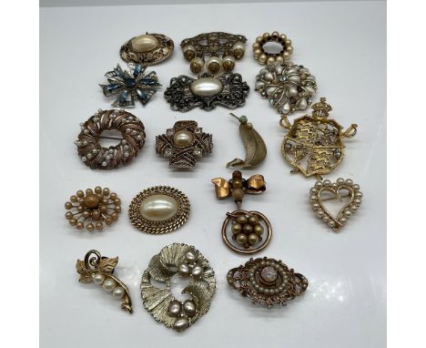 A collection of 17 vintage costume jewelry brooches featuring a variety of designs, materials, and embellishments. This lot i