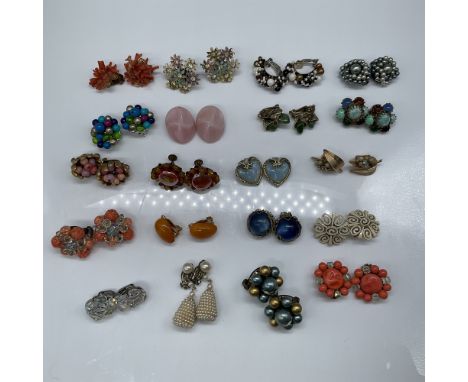 A stunning collection of 20 pairs of vintage clip-on earrings, each reflecting a unique design and timeless charm. This curat