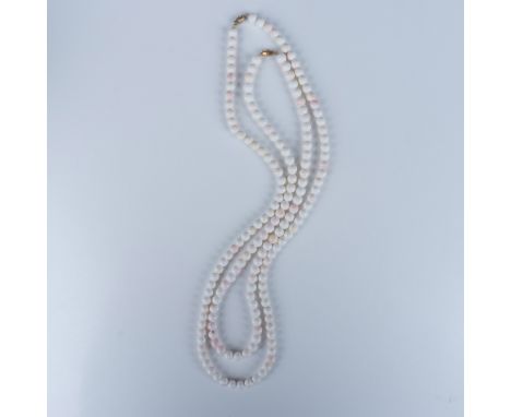 Wonderful duo of barrel clasp necklaces that includes a matching set of white and speckled pink colored beads connected with 