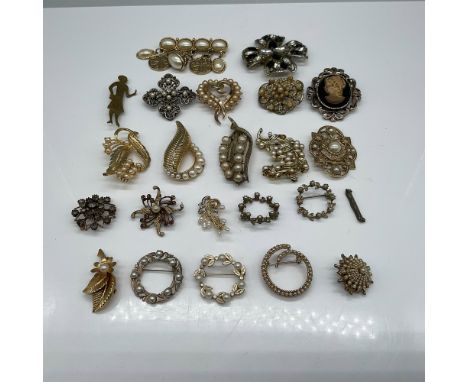 A charming collection of vintage brooches featuring gold-tone metal designs adorned with faux pearls, rhinestones, and intric