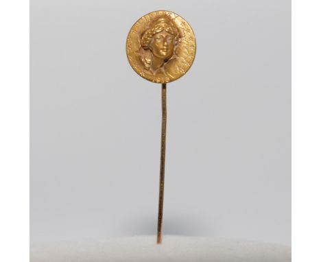 This elegant stick pin features a finely detailed 22k gold top depicting a bust with a classical design, complemented by an 1