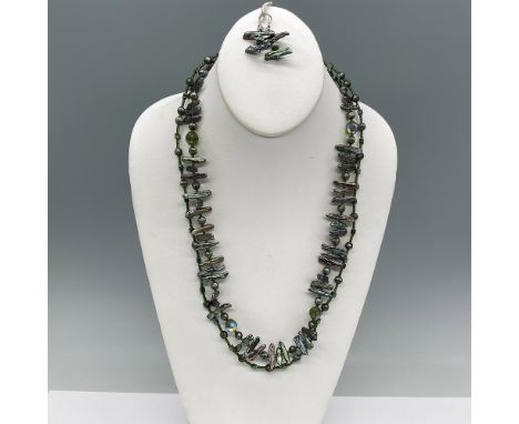 An exquisite handmade jewelry set featuring a double-strand necklace and matching earrings. The necklace is crafted with vibr