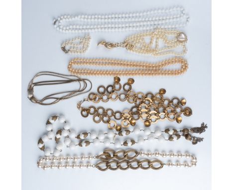 An elegant collection of nine vintage jewelry pieces, including an assortment of necklaces and bracelets in gold-tone metal, 